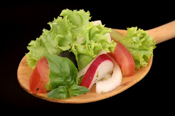 wooden spoon with garden salad