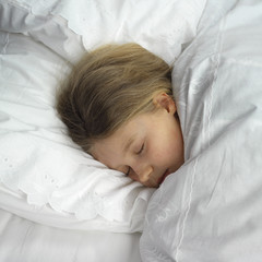 sleeping girl in clean white sheets