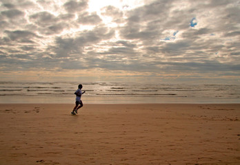 Fototapeta na wymiar girl running on a beach