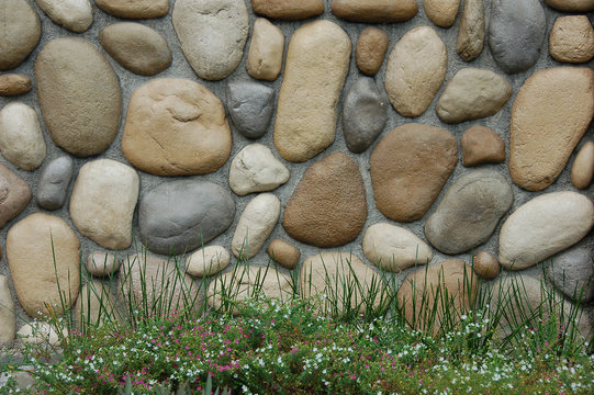 stone wall with flower bay infront
