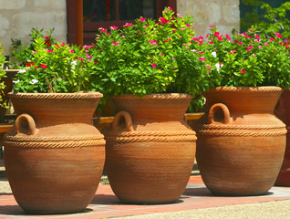 three coiled clay pots