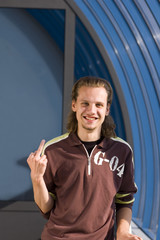 smiling man is showing his middle finger
