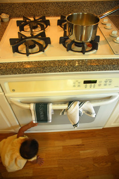 Child Playing In Kitchen