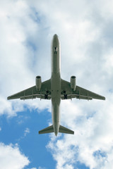 jet landing in cloudy sky