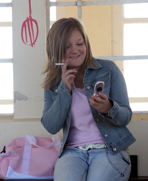 teen smoking with cell phone