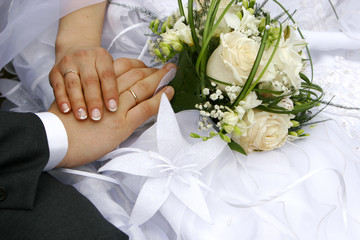 just married - hands, rings and bouquet