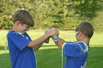 boys shooting each other with string