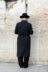a man praying at the western wall