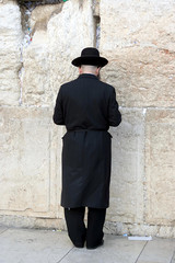 a man praying at the western wall