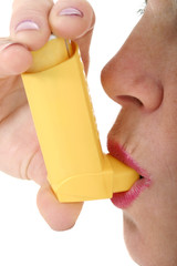 woman using asthma inhaler