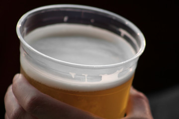 beer in a plastic cup.