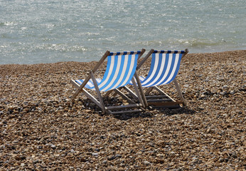 deckchairs on pebble beach