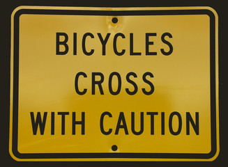 bicycles cross with caution, yellow and black street road  sign