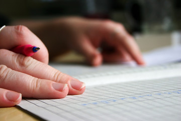 hand with pen/accounting