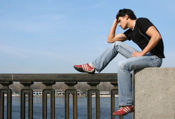 young man at the embankment
