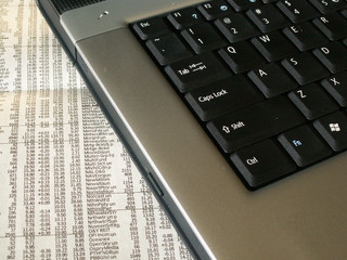 notebook computer on the business page of the news