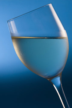 chilled white wine on blue background
