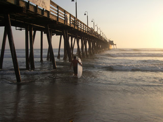 surfer by pier