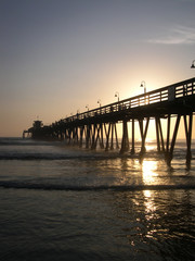 Fototapeta na wymiar sun setting on the pier vertical