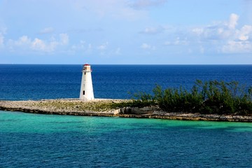 white lighthouse surrounded by deep blue ocean