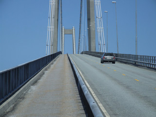 car driving over a big bridge