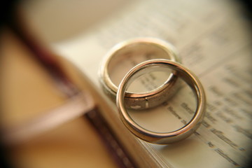 gold wedding rings on bible