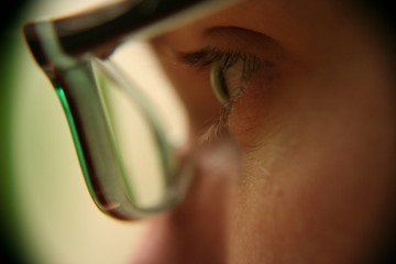 profile shot of green eye and glasses