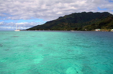 turquoise lagoon with a sailboat