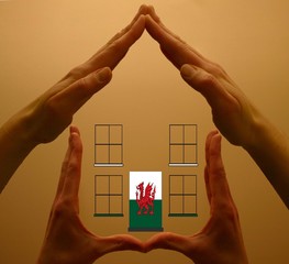 hands holding welsh house