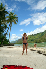 woman taking a picture on the beach