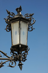 Fototapeta na wymiar street lantern across blue sky