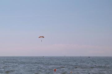 paraglider over a sea on the blue sky.