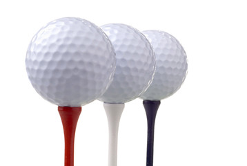 golf balls on red, white & blue tees