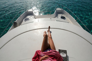 woman lying on a boat - obrazy, fototapety, plakaty