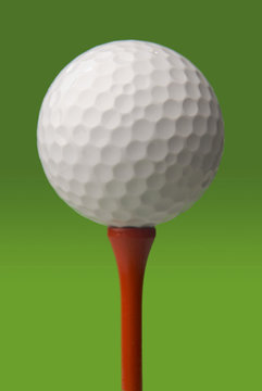 golf ball on red tee, green background