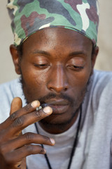 rastafarian man smoking marijuana