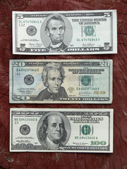 dollar notes against wooden background