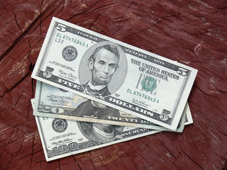 dollar notes against wooden background