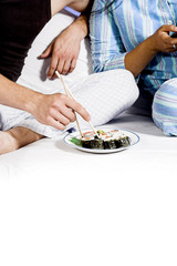Obraz na płótnie Canvas eating sushie on couch