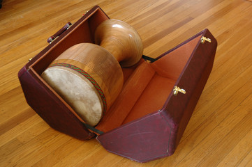 a goblet hand drum in a hexagon wooden case
