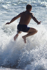 man jumping over the wave