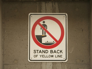 stand back from yellow line sign
