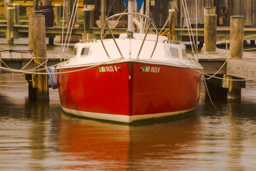 red docked sailboat