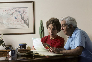 retired couple work on financial records