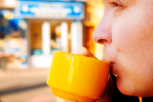 Young Man Drinking Coffee Outside