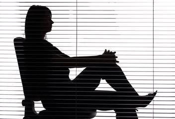 silhouette of woman sitting in the office (blind)