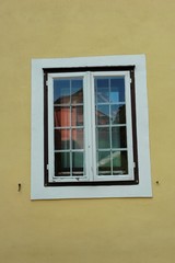window with reflection of church on roznik