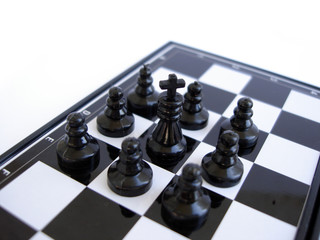 chess king stands on a chess board with figures