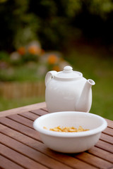 white jug and bowl with corn flakes on table