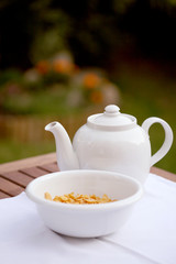white jug and bowl with corn flakes on table